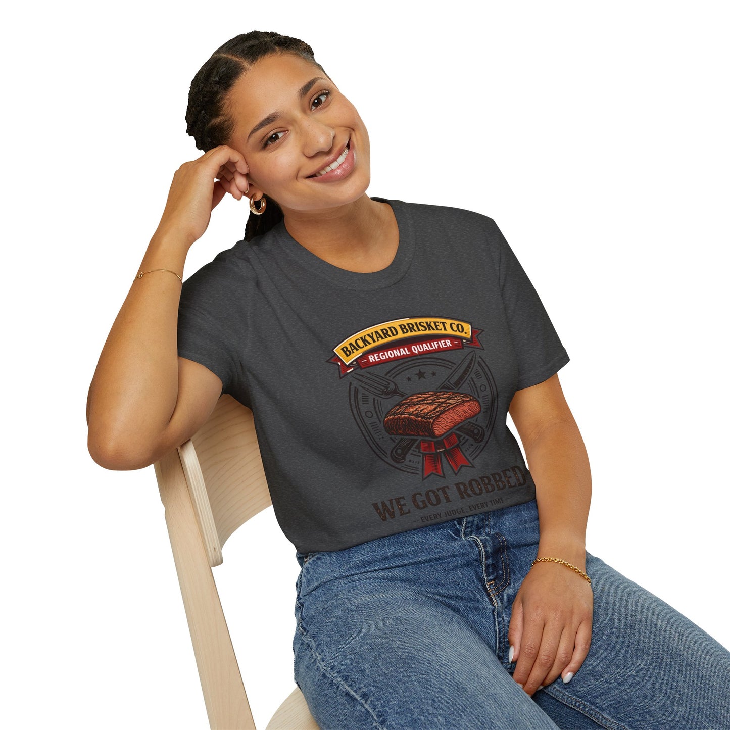 Backyard Brisket Co. Shirt, Dark Heather charcoal, worn by a model seated on a wooden chair