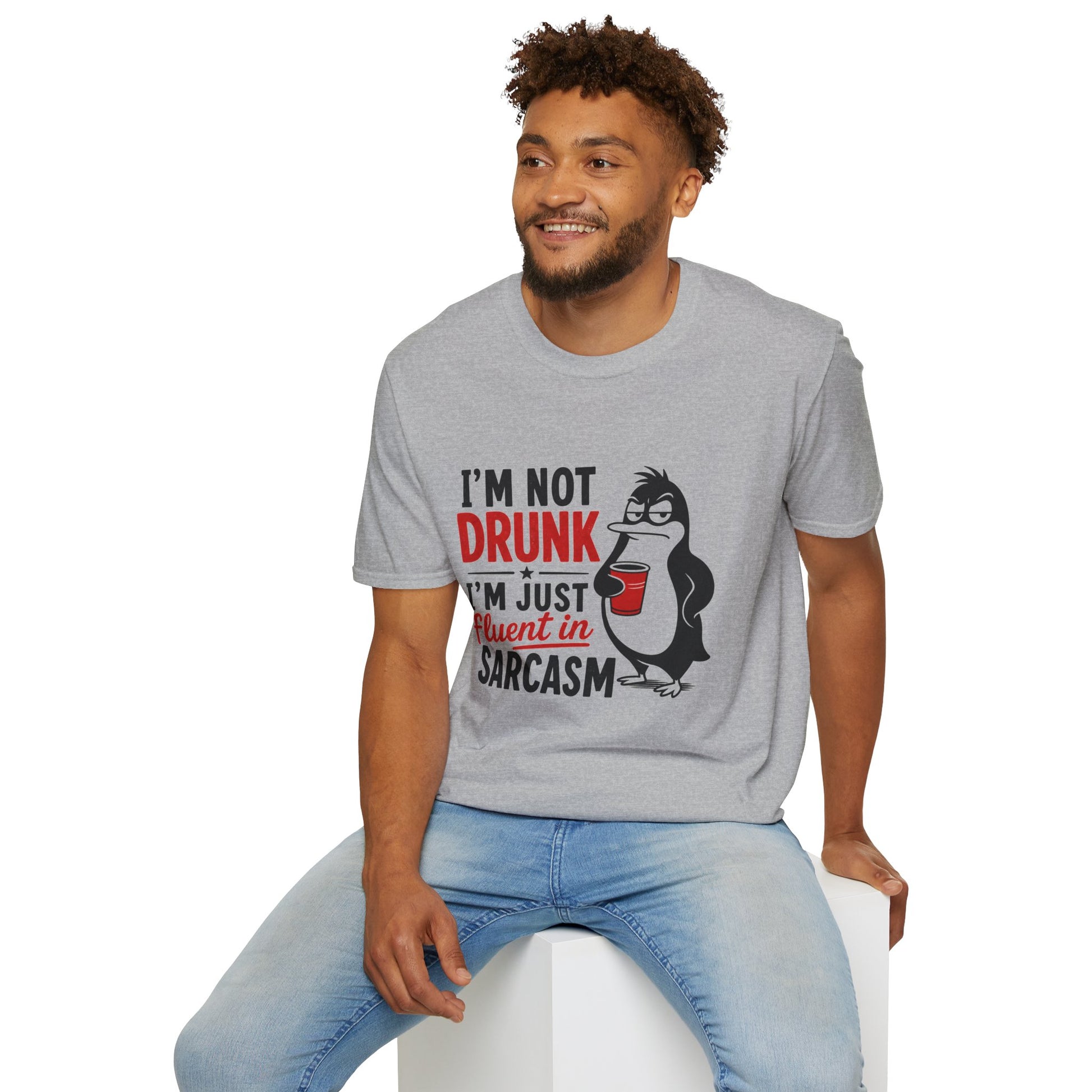 I'm Not Drunk, I'm Just Fluent in Sarcasm Shirt, Sport Grey, worn by a model seated on a white block