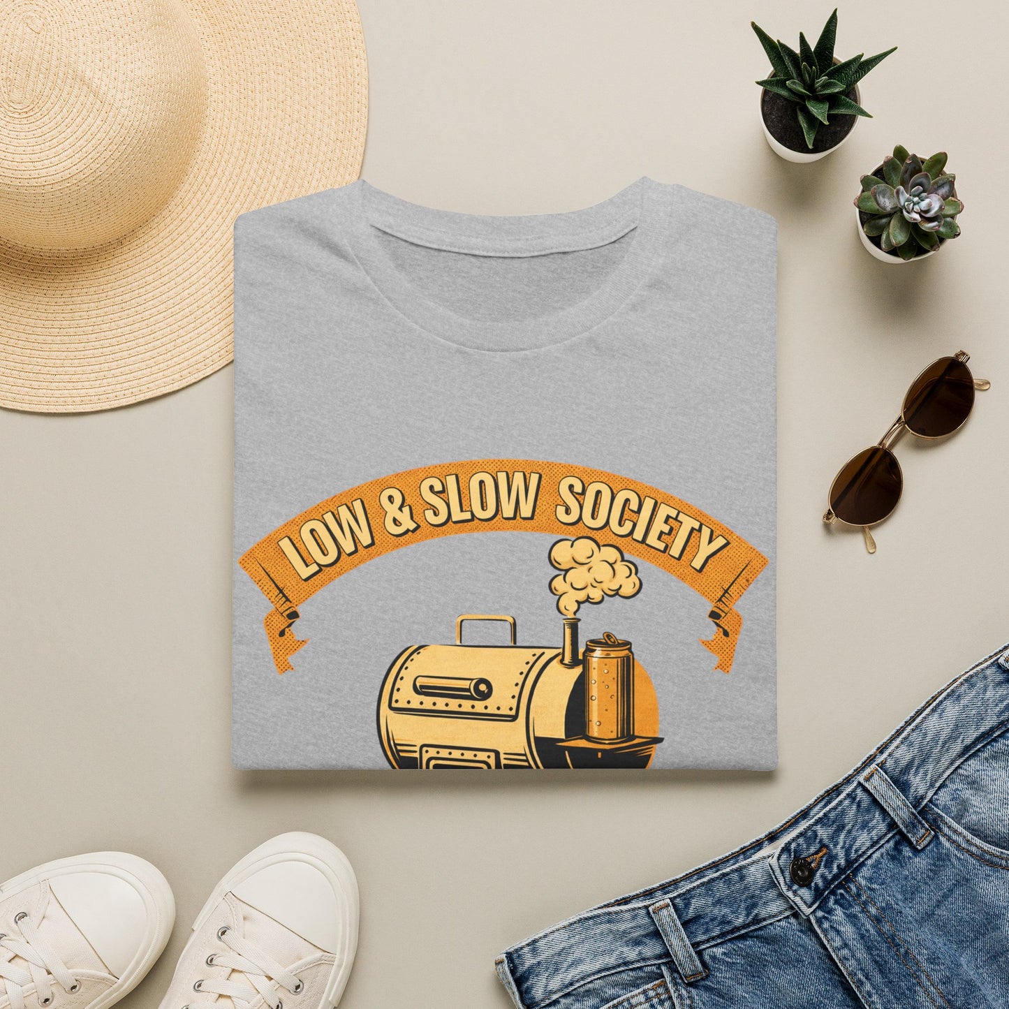 Low & Slow Society Shirt, Sport Grey, folded flat lay styled with a straw hat, sunglasses, sneakers and denim