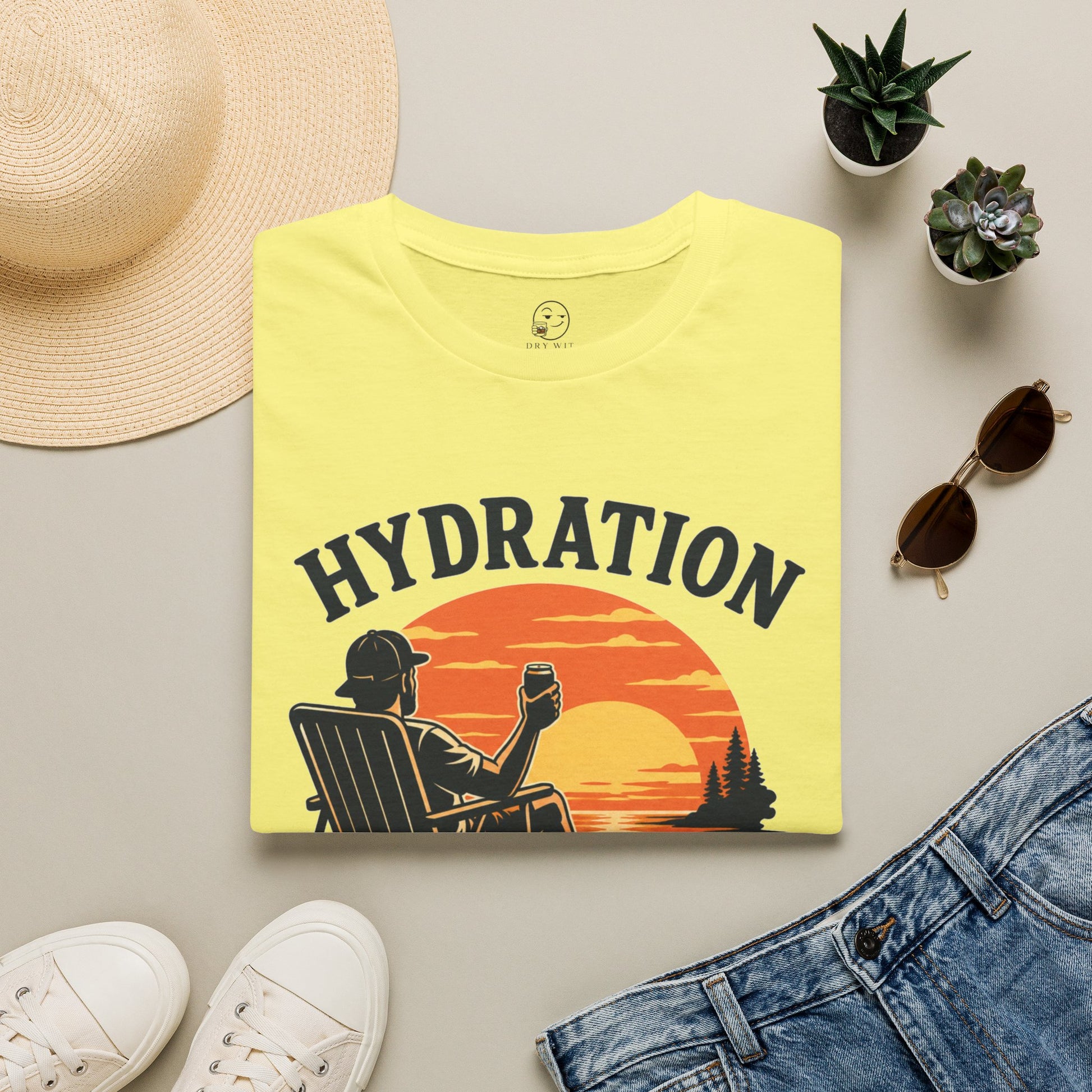 Hydration Is Tomorrow's Problem Shirt, Cornsilk pale yellow, folded flat lay styled with a straw hat, sunglasses, sneakers and denim