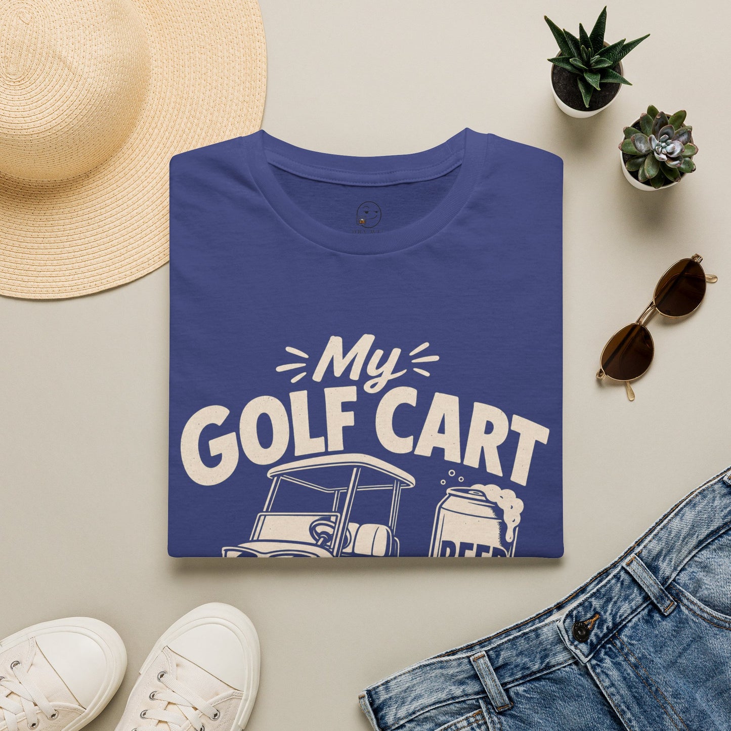 My Golf Cart Runs on Beer Shirt, Metro Blue, folded flat lay styled with a straw hat, sunglasses, sneakers and denim