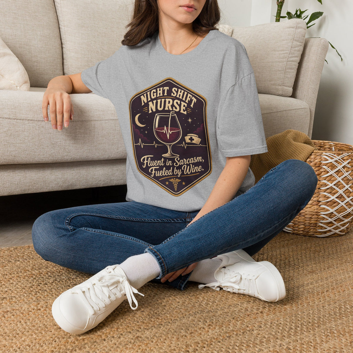 Fluent in Sarcasm Shirt, Sport Grey, worn by a model seated on the floor beside a sofa