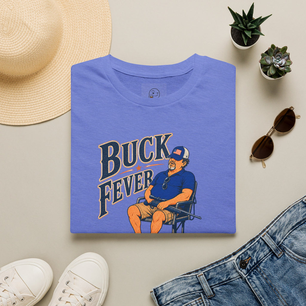 Buck Fever Outfitters Shirt, Heather Royal blue, folded flat lay styled with a straw hat, sunglasses, sneakers and denim